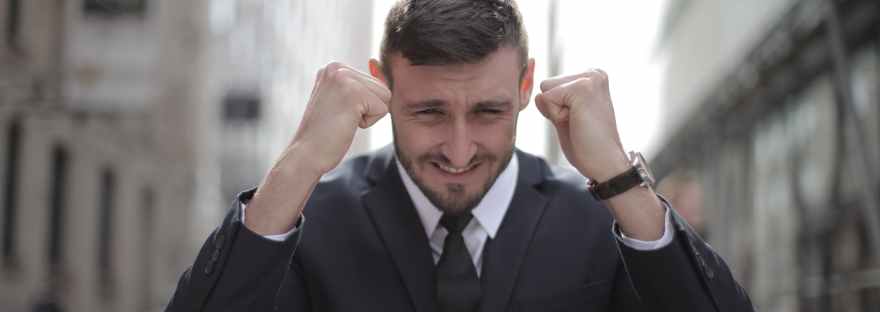 man in black suit achieved an accomplishment