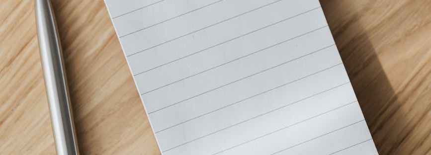 opened notebook and silver pen on desk