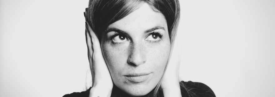 close up photo of woman covering her ears