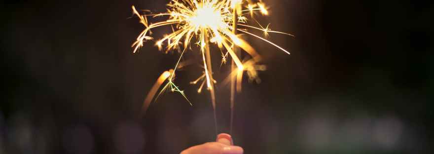 person holding lighted sparkler