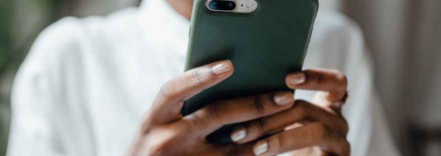 black woman messaging on modern cellphone